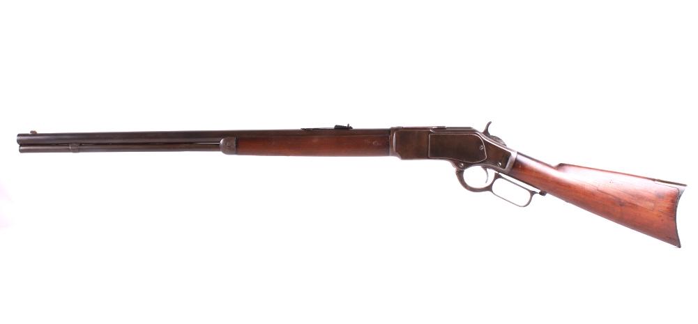 Winchester Model 1873 Lever Action .32 WCF Rifle: One of the earliest Winchester Model 1873 rifles produced with standard 24” round barrel, full magazine, crescent butt plate and chambered for the popular .32 Winchester Center Fire cartridge. It is