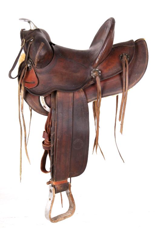 Heiser High Backed Tooled Western Saddle: In this lot we have a Heiser High Backed Tooled Western Saddle. This saddle has tooling down both fenders along with more tooling on the cantle and back housing of the saddle. You can see the stamp of