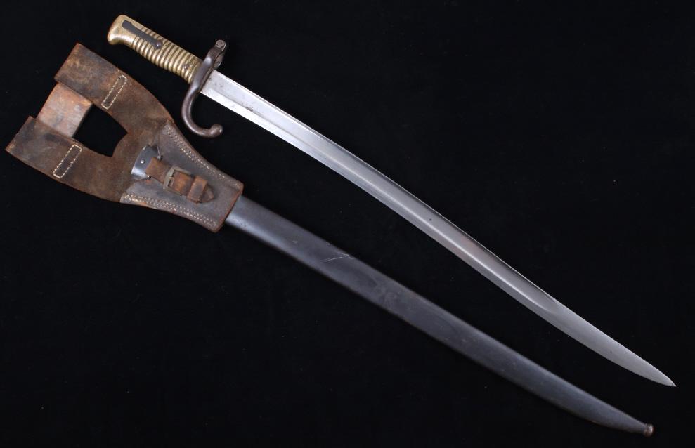 M1866 French Yataghan Sword Bayonet: Available in this lot we have a M1866 French Yataghan sword bayonet with metal scabbard and leather frog. The sword bayonet is designed to fit on the 11 mm. M1866 Chassepot needle fire rifle. The bayo
