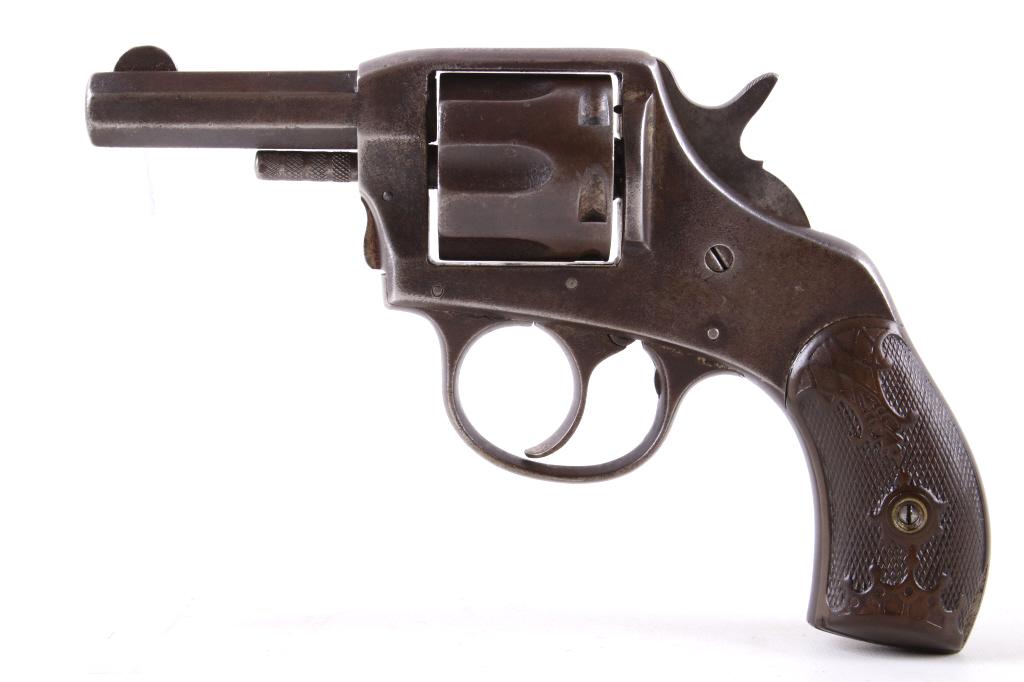 H&R "The American" .32 CF Revolver: This is a Harrington & Richardson "The American" double action revolver chambered for the .32 center fire. The revolver features a blue’d finished steel full octagon 2 1/2" barrel, frame and 5-shot 