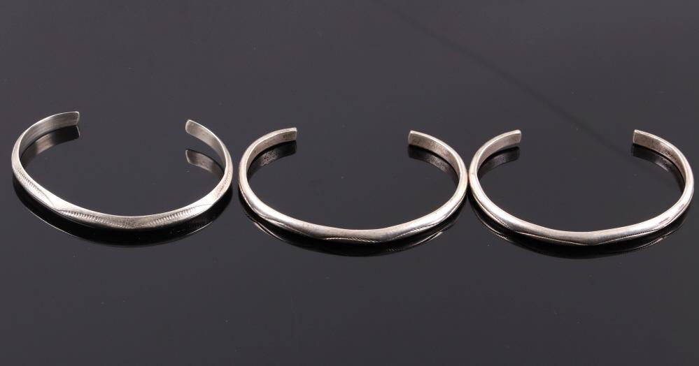 Set of Navajo Sterling Silver Bracelets: Available in this lot we have a collection of Navajo Native American sterling silver bracelets. The collection consists of three sterling silver cuffs. The first and second bracelets show hand tooled