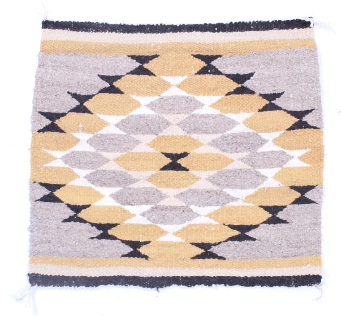 Navajo Eye Dazzler Crownpoint Rug by Ruth Nelwood: The lot features an original Crownpoint, New Mexico Trading Post wool rug from Ruth Nelwood with an Eye Dazzler pattern. The rug shows a 1960’s age with100% wool mineral dyed construction. The rug c