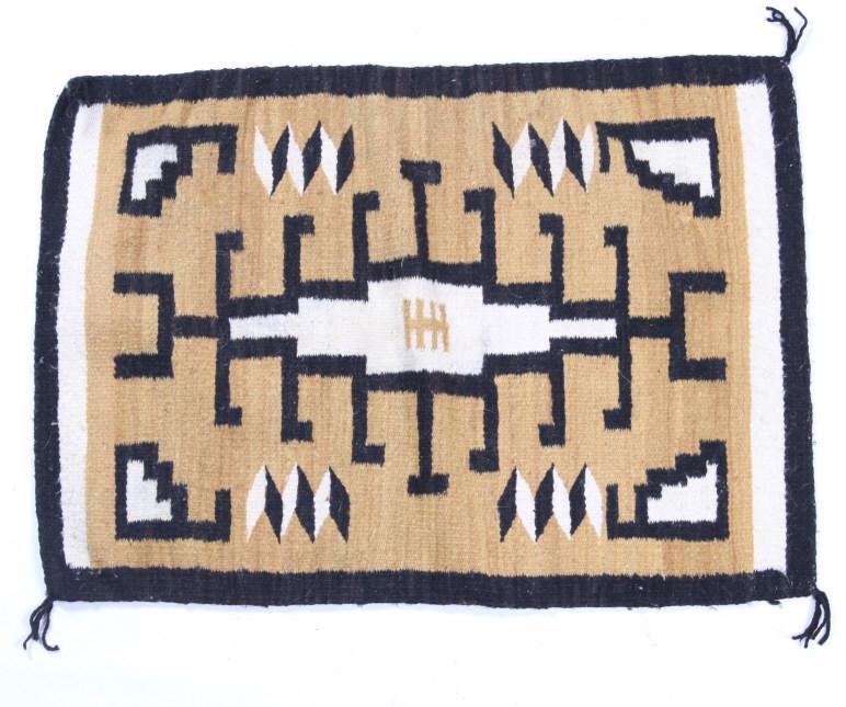 Navajo Two Grey Hills Trading Post Rug: The lot features a trading post rug with a fantastic Two Grey Hills pattern from the Navajo Native American Indians and the 1950's. The rug shows a barred and tiered black diamond pattern and colors o