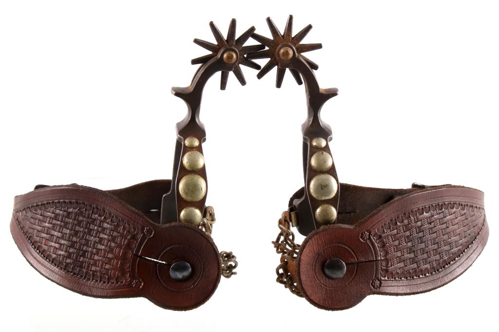 August Buermann Spotted Silver Mounted Spurs c1900: The lot features a set of California pattern spurs decorated with five graduated silver mounted spots dating to the early 1900’s. The set is attributed to August Buermann and is unmarked showing a o