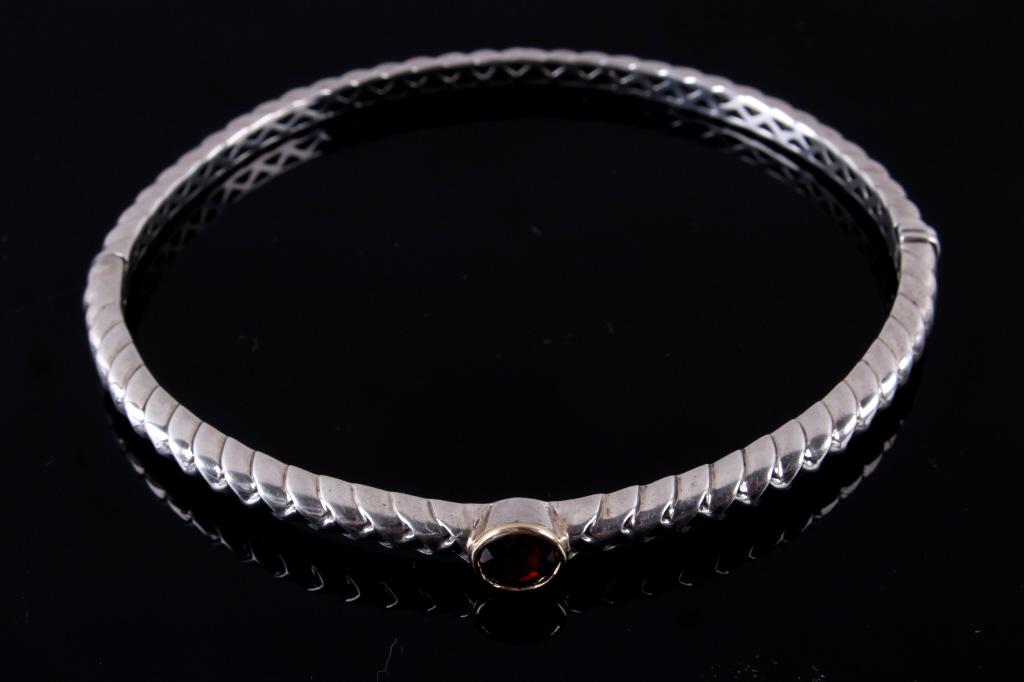 14K White Gold & Red Garnet Bracelet: For your consideration is a 14k white gold and garnet bracelet. This bracelet has a twisted braid design around the cuff and is fixed with a faceted garnet gemstone. The bracelet has a hinge action th