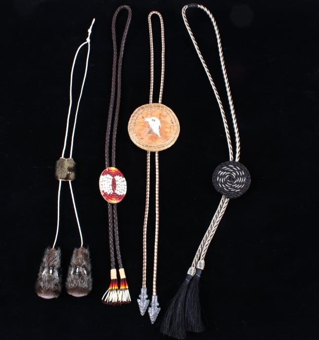 Plains Indian Quill & Horse Hair Bolo Ties: Included in this lot we have a collection of four Plains Indian horse hair, quill, or birch bolo ties. The first of the ties displays a oval slide with colorful quill design across the front. The bolo