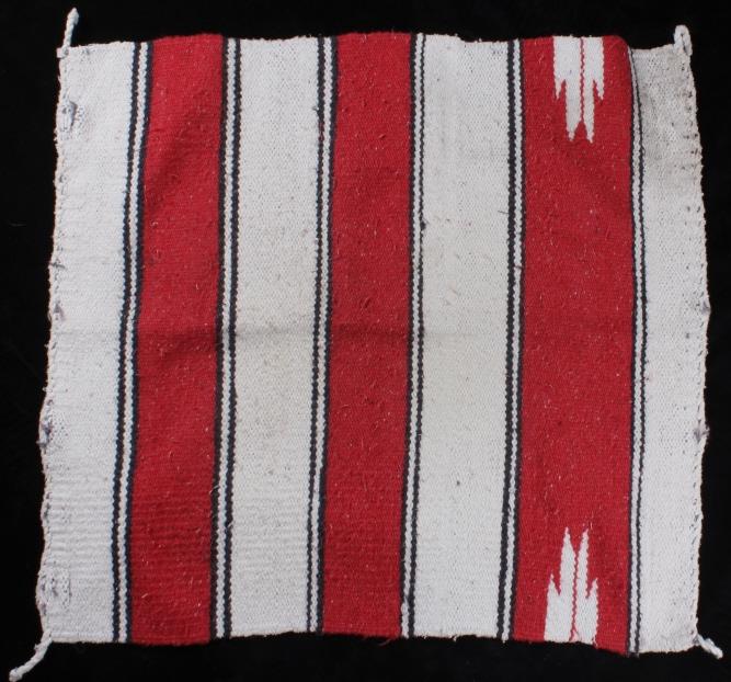 Zapotec Red and Cream Saddle Blanket: In this lot we have a Zapotec red and cream saddle blanket. This blanket has Alternating colors that go back and fourth between cream white and read with a small black line to separate the two colors.