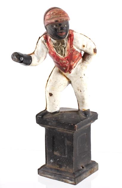 Antique Cast Iron Black Lawn Jockey Statue: This is an antique lawn jockey. It is made from solid cast iron. The statue is a black man dressed in a jockey suit and hat. It shows good condition showing some rust and paint loss. Also, the paint o