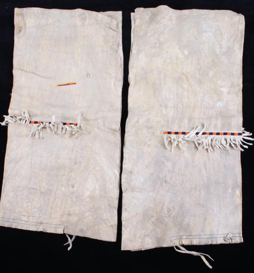 Crow Beaded Buffalo Hide Men's Leggings 1950-60's: The lot features a fine set of Buffalo Hide leggings with beadwork from the Crow Native American Indians of Montana. The set, with a nice vintage circa 1950-1960’s age, shows a thick Great American