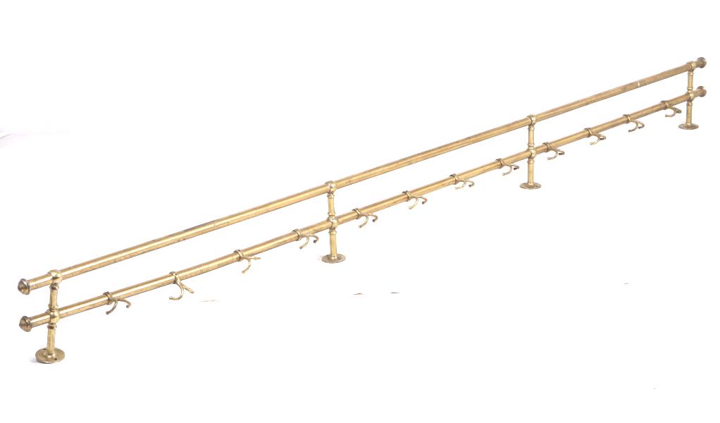Early 1900's Brass Hotel Hallway Coat Rack: Featured in this lot we have a brass hotel hallway coat rack originating from the early 1900's. The piece displays brass construction with iron reinforcement on the bars. The coat rack displays twelve