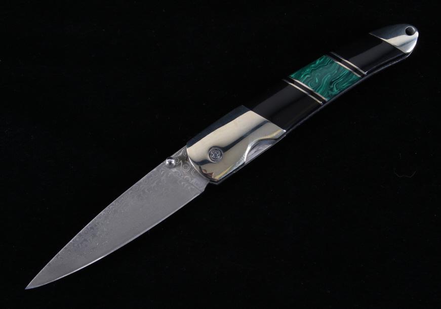 Damascus Malachite & Jet Custom Knife: This is an original handmade custom knife showing a damascus blade with premium Malachite and Jet stone grips. The knife is from Santa Fe Stone-works. The grips have a silver, black jet and malachite