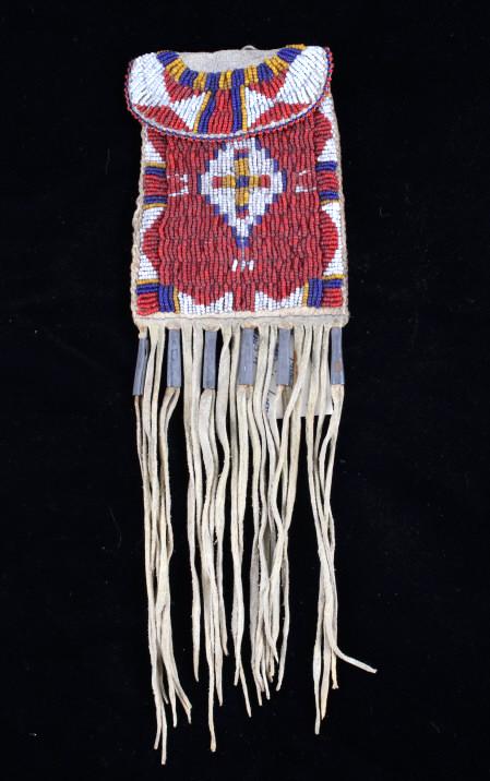 Apache Beaded Strike-A-Lite Possible Bag c. 1900-: The lot features a finely beaded strike-a-lite possible bag from the Apache Native American Indians and dating to circa 1900-1920’s. The bag shows an Indian tanned Buffalo Bison hide with all glass 