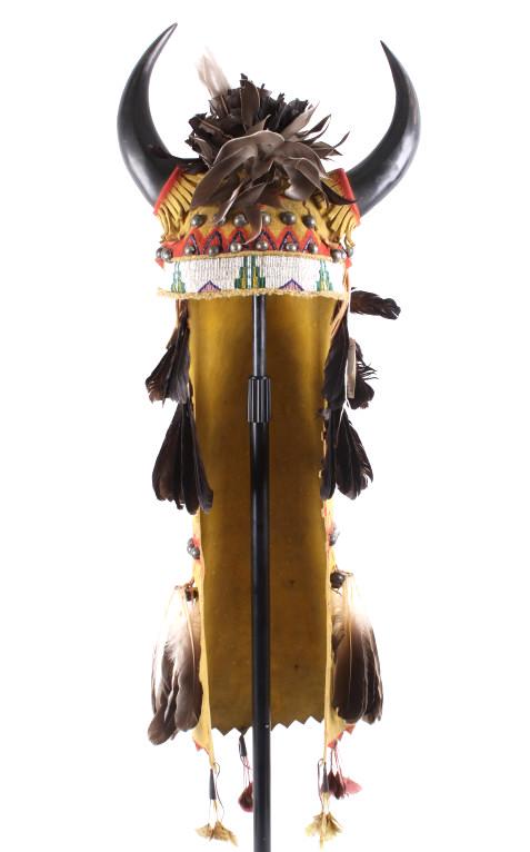 Sioux Beaded Hide Split Horn Buffalo Headdress: The lot features a beaded hide split horn Buffalo headdress attributed to the Sioux Native American Indians. The headdress shows a Indian brain tanned hide, possibly Buffalo, with beaded brow band and