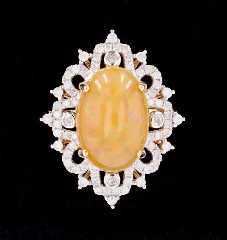 Australian Fire Opal & Diamond 14K Gold Ring: The lot features a gorgeous classic antique style ring showing an excellent large Australian Fire Opal surrounded by natural Diamonds and set in 14K yellow gold. The ring comes with AIGL paperwork and