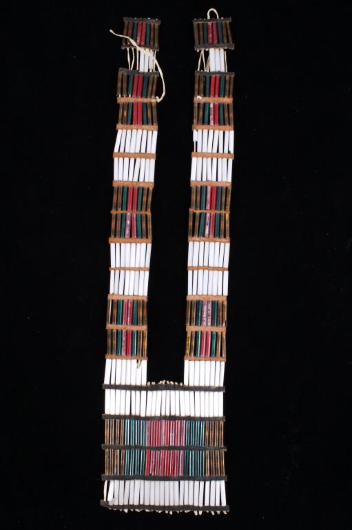 Northern Plains Bugle Beaded Breastplate Pre-1900: The lot features a pre-1900 bugle glass beaded breastplate from the Northern Plains Native American Indians, likely the Crow. The piece shows Indian tanned hide strung Czechoslovakia bugle tube glass