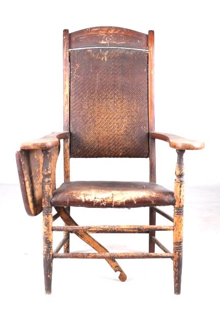 Late 1800s Ford Johnson & Co Fold Out Desk Chair: Featured in this lot we have a J. S. Ford Johnson and Company chair with fold out desk originating from the late 1800's to early 1900's. The chair displays sold wood construction with a leather seat a