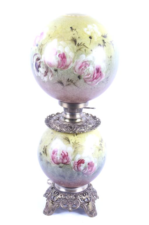 Gone With The Wind Painted Glass Parlor Lamp: Included in this lot we have a Gone with the Wind painted glass parlor converted lamp originating from the early to mid 1900's. The lamp displays brass construction with two large decorative glass glo