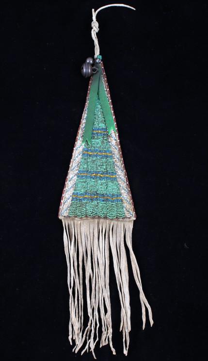 Sioux Fully Beaded Tomahawk Hide Drop 1900-1950: The lot features an Indian tanned hide fully top beaded tomahawk drop from the Sioux Native American Indians dating to circa 1900-1950's. The Reservation era drop would have been attached to a pipe to