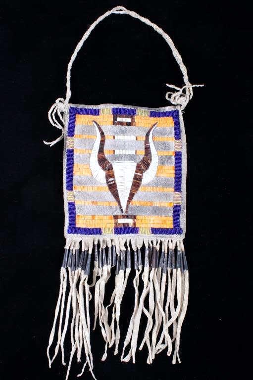 Cheyenne Buffalo Quilled & Beaded Society Pouch: This is an interesting circa late 19th to early 20th hide society pouch flat bag with quilled and beaded design showing a Buffalo Head from the Cheyenne Native American Indians. The bag shows a flat s