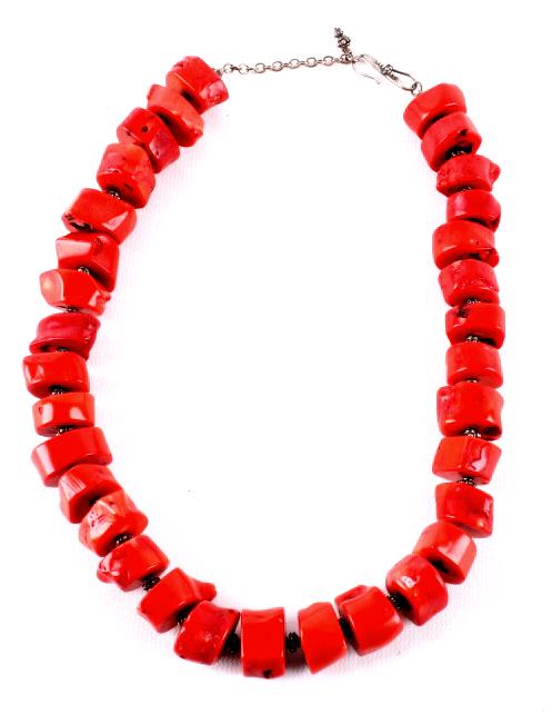Sterling & Ox Blood Coral Nugget Necklace: Featured in this lot we have a large nugget ox blood coral necklace with sterling silver clasp. This piece shows thirty two large cuts of ox blood coral with sterling silver trade beads separating the