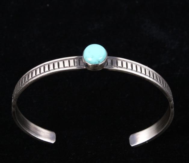 Navajo R. Enriquez Silver & Kingman Turquoise Cuff: For your consideration is a signed Navajo Native American Rick Enriquez sterling silver and Kingman turquoise bracelet. This stunning petite bracelet features a heavily stamped design throughout the c
