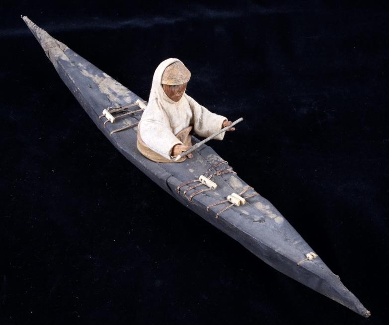 Eskimo Model Kayak circa 1900: The lot features an excellent Eskimo Inuit Native American Indian model kayak dating from circa 1900. The piece shows a wood frame canvas covered kayak boat showing a greased or waxed surface with sea