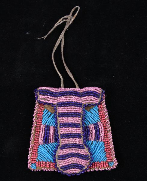 Northern Cheyenne Beaded Strike-A-Lite Bag 1800's: The lot features a hide beaded strike-a-lite bag from the Northern Cheyenne Native American Indians of the 19th Century. The piece shows an Indian tanned hide construction with hide flap all being com