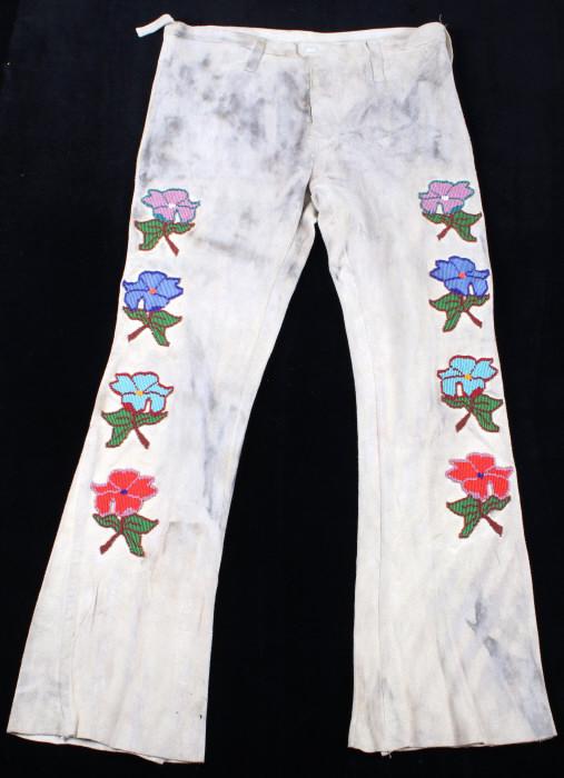 Santee Sioux Floral Beaded Men's Hide Pants c1900-: The lot features a set of hide pants from a Santee Sioux Native American Indian man with floral beadwork dating to early-to-mid-1900’s. The pants feature an Indian tanned hide construction with trad