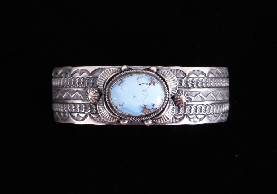 Navajo Golden Hills Turquoise Sterling Bracelet: Included in this lot is a Jane Delgarito Navajo Native American Golden Hills turquoise sterling silver bracelet. This beautiful bracelet features a heavily hand stamped design. The deep hand stamped m