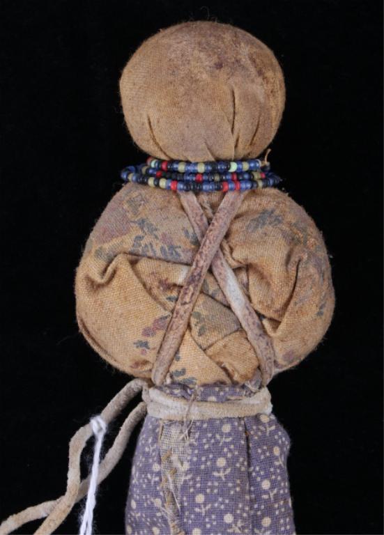 Crow Child's Doll w/ Beadwork c. 1880's: The lot features a circa 1880’s child’s hide and fabric doll with beadwork from the Crow Native American Indians. This 19th Century example comes with a museum collection tag, as shown. The doll s