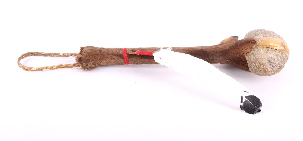 Plains Indian Style Deer Leg & Stone Club: In this lot is a Plains Indian style war club with a stone head, deer bone and hide handle, and decorative feather. The handle is made from the lower part of a large deer leg bone and hide. The piece 