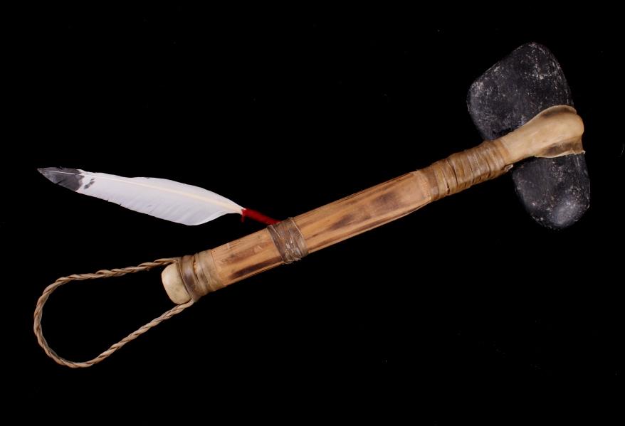 Plains Indian Style Stone War Club: The lot features a Plains Indian style stone axe war club. The piece shows a stone head, which is secured to the split top wood handle with strips of rawhide parfleche wrapped and dried to secure the 