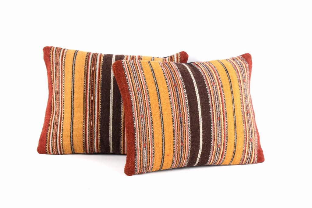 Olas de la Tierra Wool Set of Two Pillows by Ruiz: The lot features an excellent set of two handwoven, flat weave pillows by master weaver Tony Ruiz. The pillows were made using 100% soft, fine, Churro Wool yarns. Churro wool is a time-tested fiber th