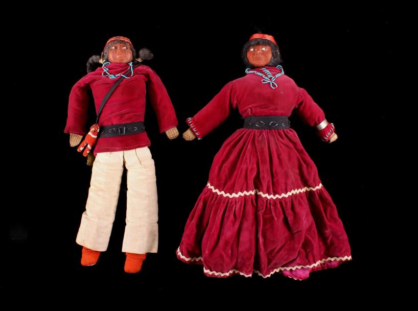 1950's Navajo Beaded Male & Female Skookum Dolls: Featured in this lot are these 1950's Navajo beaded, male & female, ceramic skookum dolls. The dolls show traditional southwest Native American design with human hair on both; the male shows garments