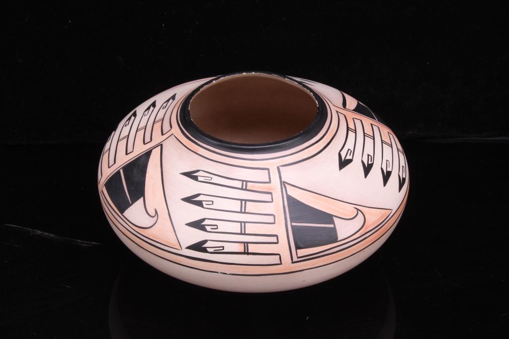 Jemez Pueblo Seed Jar by C. Gachupin: Included in this lot is a hand-painted, Jemez Pueblo seed jar made by artist C. Gachupin. This seed jar displays a red base opening up to a light pink and black geometric design. The bottom of this pi