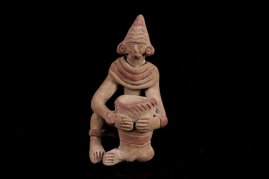 Pre-Columbian Mayan Clay Effigy: Included in this lot is a pre-Columbian, Mayan clay effigy. This effigy shows a man sitting down holding a pot in his hand that is also balanced on his left leg. The man is wearing a small headpiece a