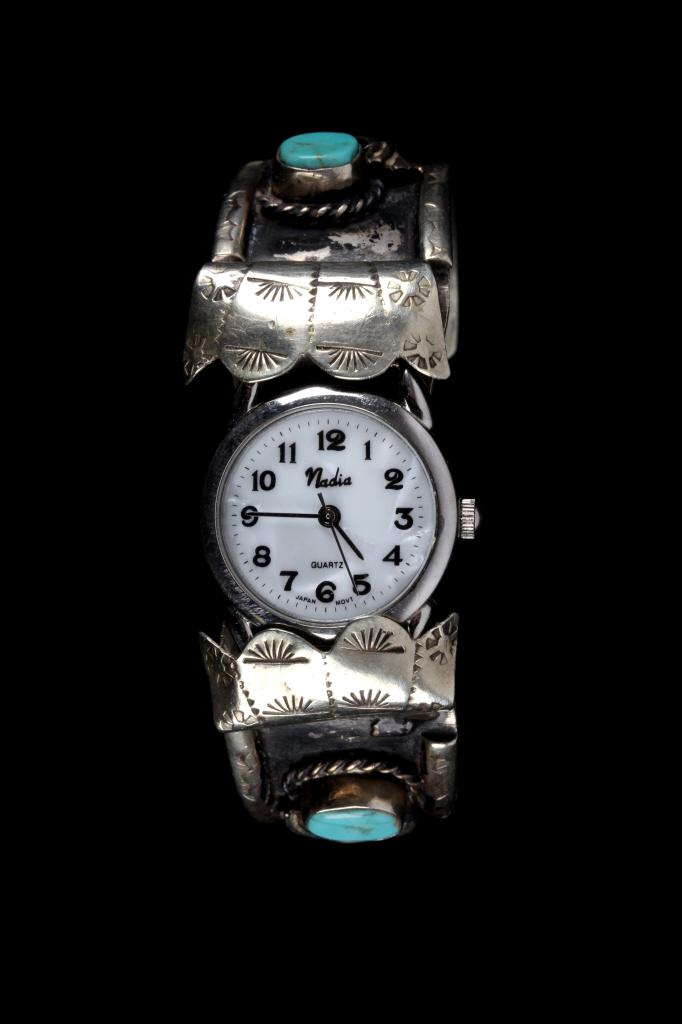 Mexico Sterling Silver & Turquoise Watch Band: This lot features a Mexico sterling silver and Turquoise Mountain turquoise watch band. The bracelet features four Turquoise Mountain gemstones expertly placed in a shadow box setting. The gemstones a
