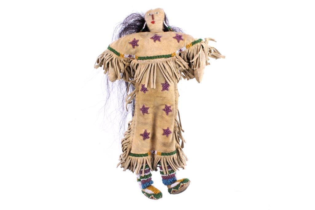 Sioux Star Beaded Hide Child's Doll w/ Real Hair: The lot features a fantastic Indian tanned hide, beaded child’s doll from the Sioux Native American Indians. The doll shows Indian tanned hide with a nice yellow ocher finish and fine hide fringe fr