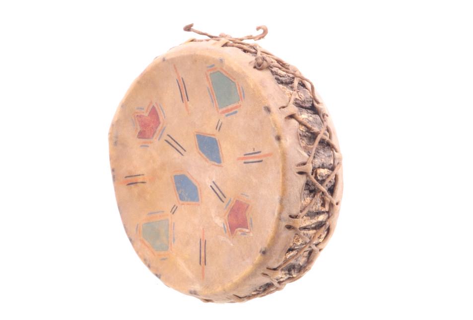 Plains Indians Polychrome Parfleche Drum c. 1900s: Featured in this lot is this Plains Indians, polychrome Parfleche wrapped drum, circa early 1900's. The drum shows a wonderfully constructed example of wetted and stretched Buffalo Bison Parfleche hid
