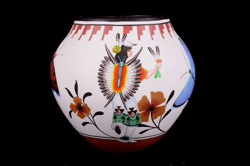 Marcellus & Elizabeth Medina Zia Decorated Pottery: Included in this lot is a stunning, original Marcellus and Medina Zia decorated monarch olla pottery. This beautiful piece portrays a Native American woman wearing traditional garments. Around the pie