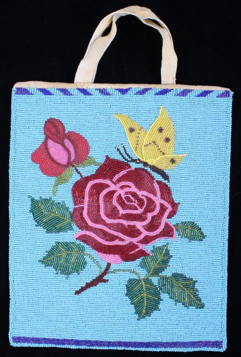 Montana Crow Fully Beaded Rose Flat Bag: This is an excellent, fully front beaded flat bag from the Montana Crow Native American Indians of the mid 1900's. The piece shows an Indian tanned hide construction with floral trade cloth inner lini
