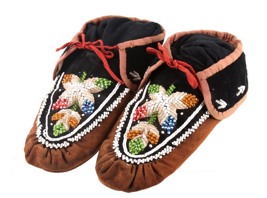 Iroquois Indian Beaded Leather Moccasins: Featured in this lot is this pair of Iroquois Indian beaded leather and cloth moccasins. The moccasins are constructed of tanned leather hide and have black trade cloth adorning the instep and heel. A