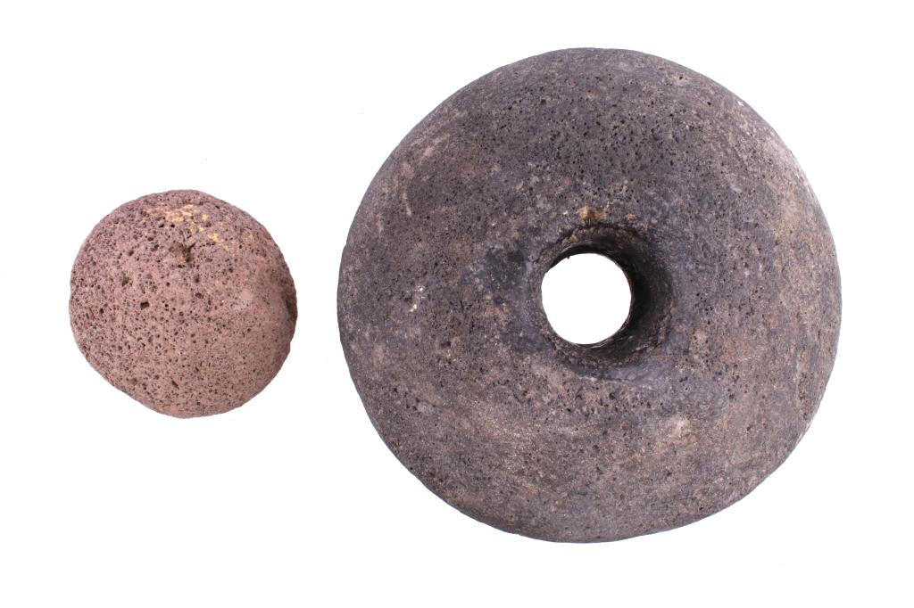Mississippian Era Milestone & Throwing Stone: Featured in this lot is this Mississippian ear milestone and throwing stone collection of artifacts. There are two artifacts in this collection. The first is a shaped throwing stone from a lighter por