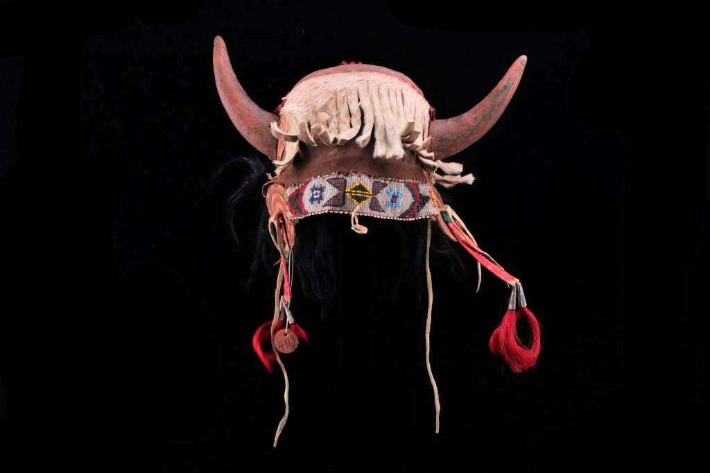 Crow Buffalo Horn Headdress War Bonnet 1890-1900: This is a very unique, rare Buffalo Horn headdress war bonnet with beadwork from the Crow Native American Indians of Montana from the late 19th Century to early 20th Century. The war bonnet shows a he