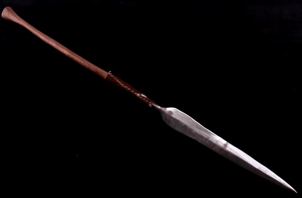 Zulu Nation, South Africa Iklwa Stabbing Spear: Featured in this lot is this Zulu Nation, South Africa Iklwa stabbing spear. The spear shows wonderful construction with a longer blade, perfect for stabbing, attached to a shorter half by a strip of 