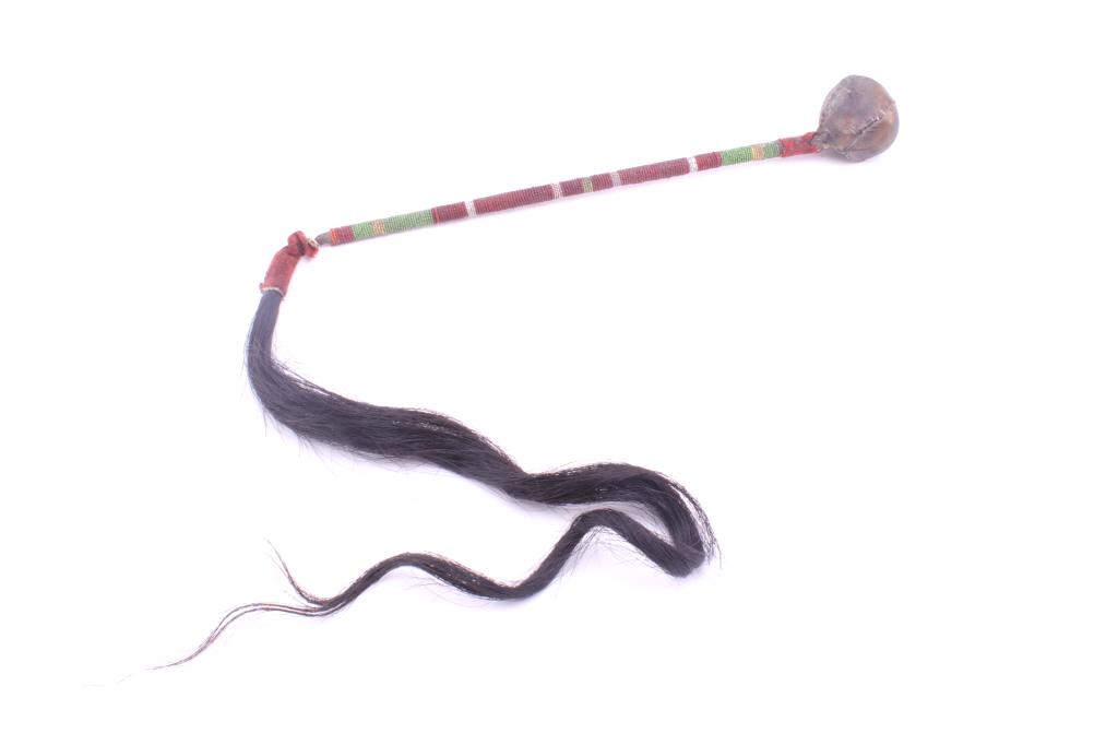 Sioux Skullcracker Stone Head War Club: The lot features a unique beaded war club with hide wrapped “floppy” stone head skull cracker war club attributed to the Sioux Native American Indians of circa 1880’s. The piece shows a large st