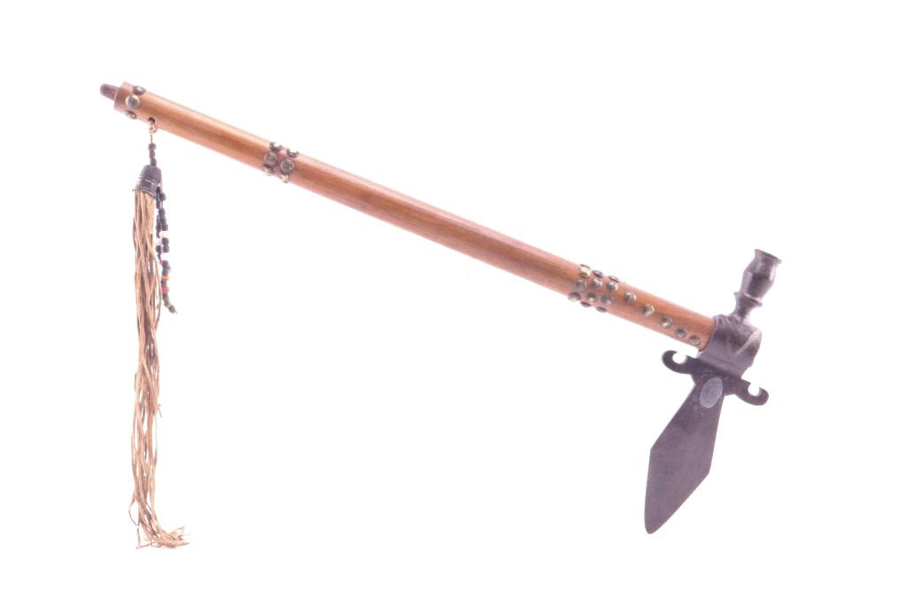 Kiowa Spontoon Pipe Tomahawk Pewter Stamped 1865: The lot features a spontoon pipe tomahawk said to be collected from the Kiowa Native American Indians at Fort Sill, Oklahoma. The iron head has a tall vase like bowl, flaring upward curled basal proce