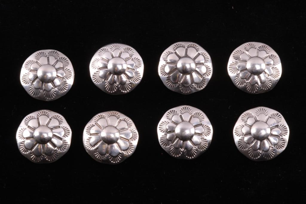Navajo Silver Floral Headstall Concho Collection: Featured in this lot is this Navajo silver floral headstall concho collection. There are eight silver conchos in this collection with a stamped and embossed floral design with nine petals and leaf sta