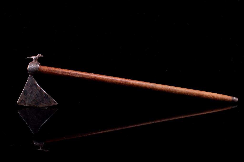 1900-1950's Bird Figure Hammer Poll Axe Tomahawk: The lot features a unique forged metal axe head with wood handle attributed to the early- to mid-1900’s. The piece shows a round eyelet hole with hammer poll of a bird effigy figure in full dimensio