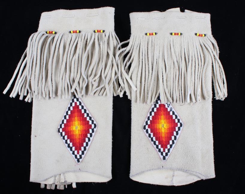 Montana Crow Hide Beaded Legging Cuffs: Included in this lot is a set of beaded legging cuffs from the Montana Crow Native American Indians. The set shows sinew sewn, soft hid construction with glass trade seed beads in a geometric pattern